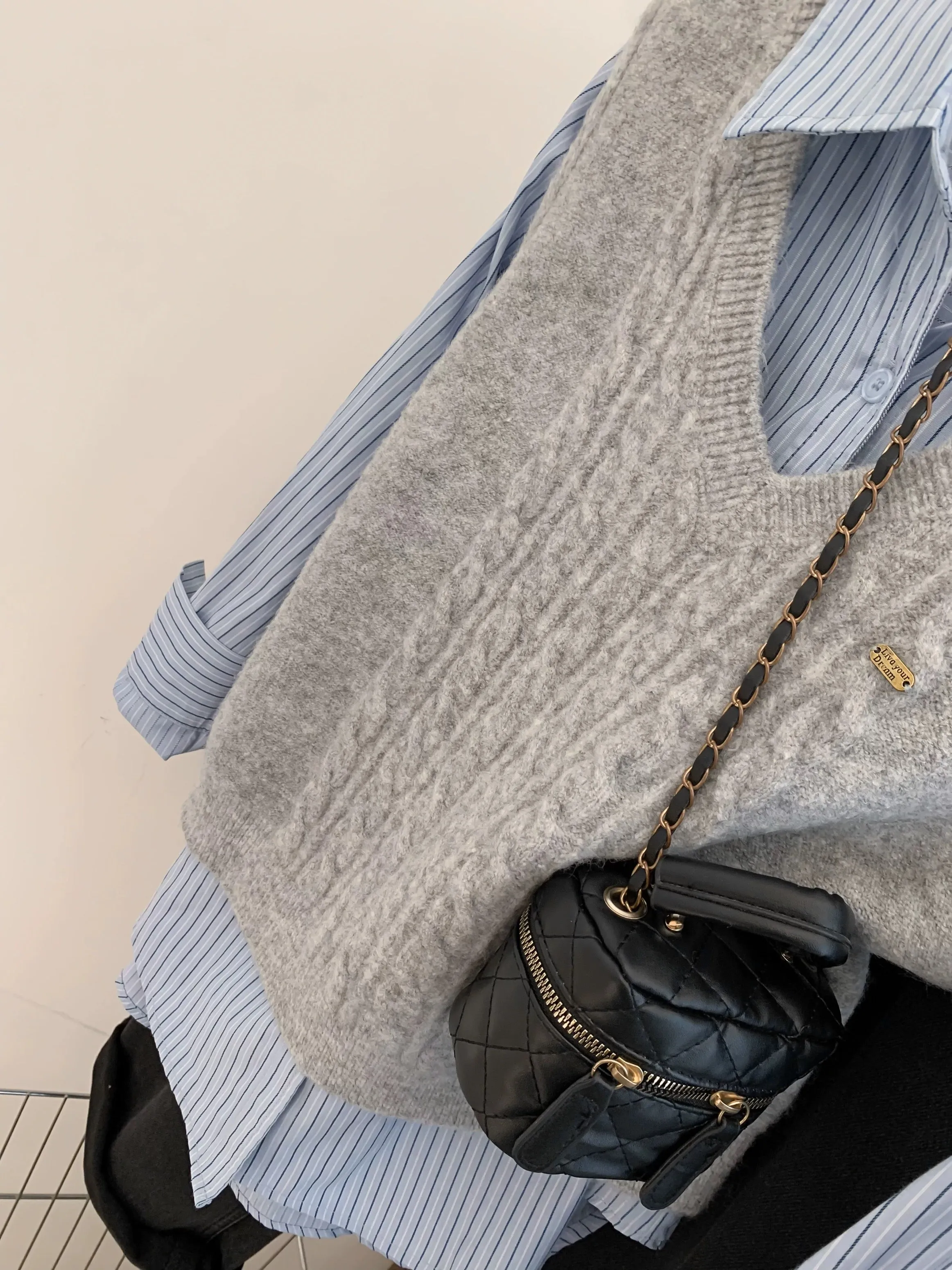 Gray V-neck sweater vest for women in spring and autumn. Small shirt with knitted vest. Layered two-piece spring outfit